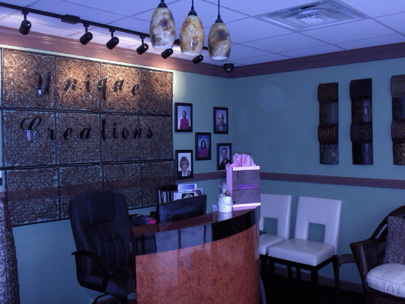 Unique Creations salon interior — teal walls and warm wood